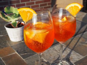 Two glasses with orange aperol spritz inside