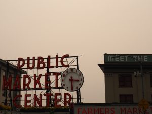 Smokey skies behind the iconic Pike Place sign.