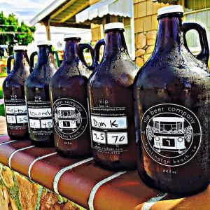 5 growlers sitting on the wall