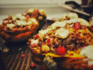 Two acorn squash halves stuffed with quinoa.