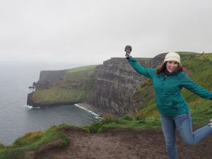 Caitlin posing near the cliffs, an epic stop on the adventure