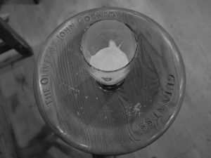 A Guinness on a carved stool.