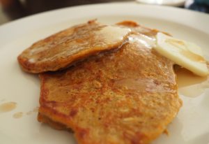 A white plate with pumpkin pancakes