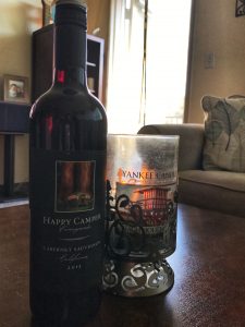 Bottle of wine next to candle