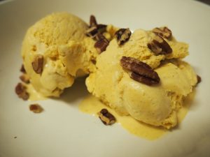 A bowl with two scoops of pumpkin bourbon ice cream