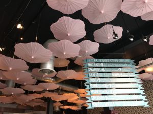 A ceiling filled with pink umbrellas at Luc Lac.