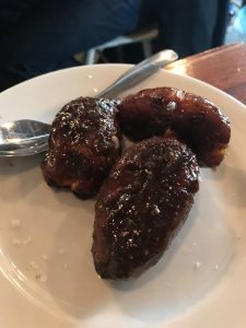 Three small yams on a small white plate.