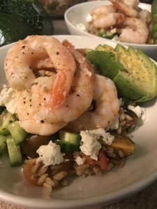 A bowl filled with farro, fruits, and shrimp.