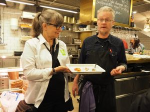 A tour guide and a chef explaining the fish courses in Sweden.