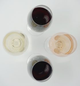 Birds eye view of four wine glasses.