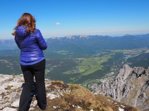 Caitlin standing at the edge of a mountain overlooking Mittenwald.