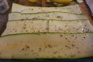 Layers of zucchini ribbons in a dish.