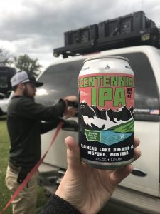 A can of Centennial IPA with Tucker and the truck in the background.