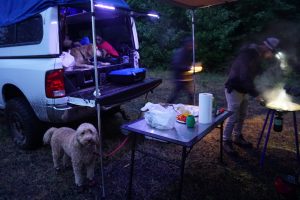 Tucker cooking under an awning in the rain.