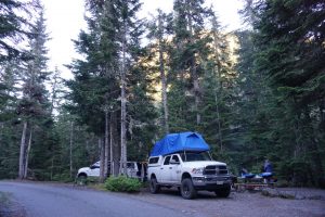 Two trucks at a campsite.