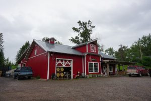 A large red barn which is home to a distillery.