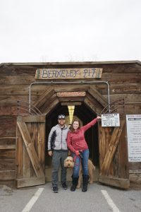 Tucker, Caitlin, and Oakley posing in front of the Berkeley Pit sign.