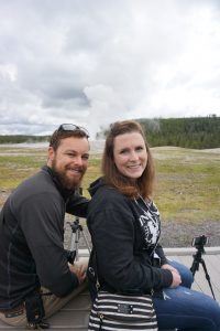 Caitlin and Tucker in front of the Old Faithful geyser.