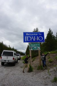 Caitlin and Tucker in front of the Idaho sign.