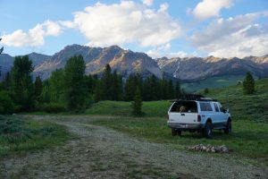 The truck parked next to a fire ring in the Sawtooth National Forest.