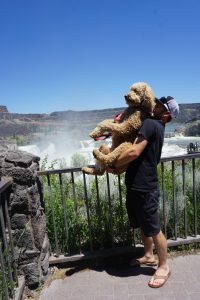 Tucker holding Oakley in front of the waterfall.