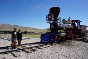 Caitlin, Tucker, and Oakley at the Golden Spike National Historic Site standing next to an old train.