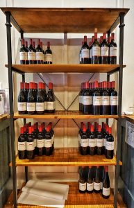 Dozens of wine bottles on display shelves.