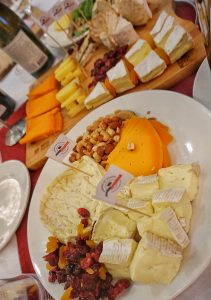 Two plates of cheese with dried fruit and nuts.