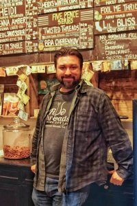 Tim Kazules standing in front of his menu board.