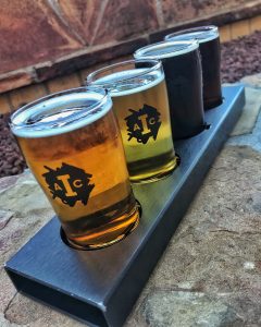 A lineup of four small beer glasses.