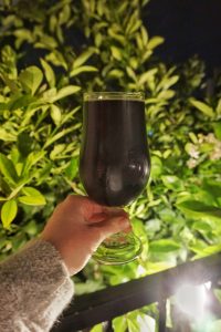 Caitlin holding a glass of Enegren Baltic Maple Porter