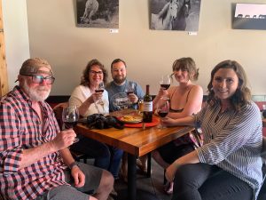 Caitlin and her family enjoying a bottle of the Armstrong Merlot.