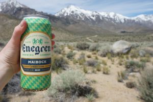 Can of Enegren Maibock Spring Laber with mountains in the background