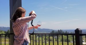 Caitlin photographing a glass of the Prelude Rosé at Bells Up Winery