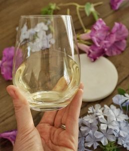 Caitlin holding a glass of riesling.