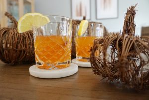 pumpkin spice hot toddy surrounded by decorative pumpkins