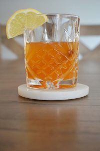 pumpkin spice hot toddy with reflection on table