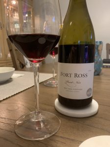 A bottle and two glasses of Fort Ross Pinot Noir.