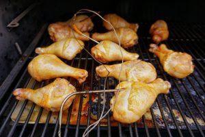 Photo of drumsticks on the Traeger grill with temperature probes.