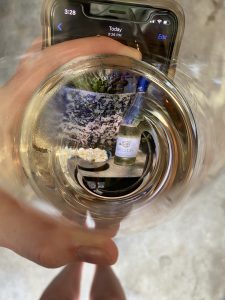 Photo looking through a glass of Helios Seyval Blanc, an Oregon wine from the Willamette Valley.