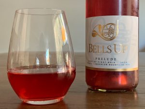 Glass of prelude rose alongside the bottle