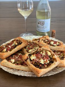 Photo of the puff pastry tartine with Bells Up Pinot Blanc in the background.