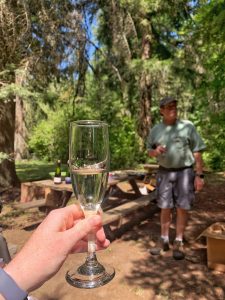 Glass of sparkling wine with Steve Bickford in the background.