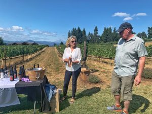 Rich Cushman describing a Stave and Stone wine while Jill House holds the bottle.