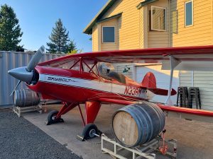 A small propeller plane parked outside of Bob's house.