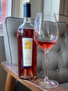 Bottle and glass of the brightly colored Rosato di Sangiovese