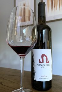 Bottle of Omega Road barbera with a glass.