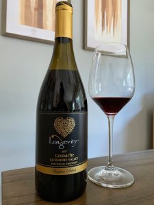 Bottle and glass of the 2017 Longevity Vintner Select Grenache